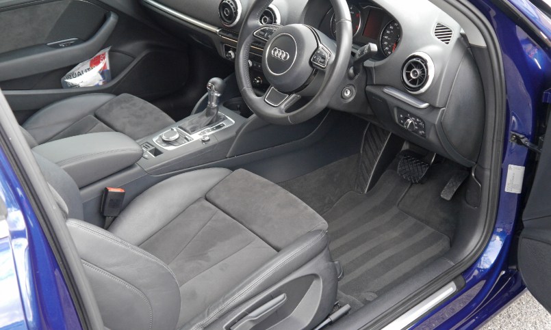 Audi A3 interior after valet, carpet stripes.